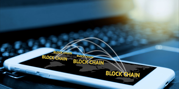 Digital money , blockchain and bitcoin concept. Block chain texts and network connect link and smartphone screen with blur laptop background , flare light