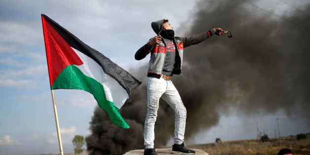 A Palestinian demonstrator uses a slingshot to hurl stones towards Israeli troops during clashes at a protest against U.S. President Donald Trump's decision to recognize Jerusalem as the capital of Israel, near the border with Israel in the east of Gaza City December 15, 2017. REUTERS/Mohammed Salem TPX IMAGES OF THE DAY