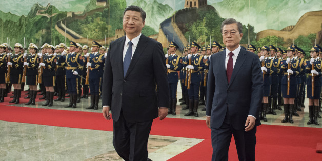 BEIJING, CHINA - DECEMBER 14: South Korean President Moon Jae-In (R) and Chinese President Xi Jinping (L) review the Chinese honour guard during a welcome ceremony at the Great Hall of the People on December 14, 2017 in Beijing, China. (Photo by Nicolas Asfouri-Pool/Getty Images)
