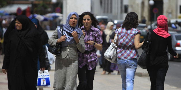 Women in different styles of dress walk in Algiers May 10, 2010. A French proposal to ban full face veils has stoked debate in Europe and also provoked strong reactions across the Mediterranean in North Africa, where many of France's Muslims trace their origins. People in North Africa are split between those who see the proposed ban -- a version of which has already been approved by Belgium's lower house of parliament -- as an attack on Islam, and those who applaud Europe for defending secular