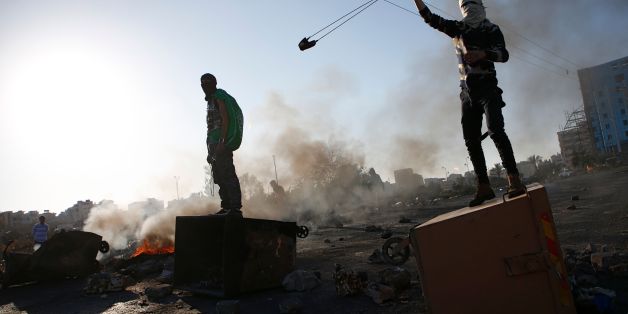 TOPSHOT - A Palestinian protestor uses a slingshot during clashes with Israeli forces near an Israeli checkpoint in the West Bank city of Ramallah on December 16, 2017, following the US president's controversial recognition of Jerusalem as Israel's capital. / AFP PHOTO / ABBAS MOMANI (Photo credit should read ABBAS MOMANI/AFP/Getty Images)