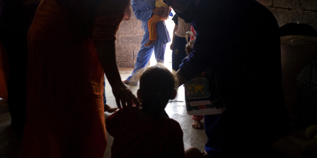 TUZ KHURMATU, IRAQ - AUGUST 25: After Sheelan Anwar Omer, 7, is circumcised by the midwife, she is presented to the other girls who have already been circumcised. Despite its reputation as the most progressive part of Iraq, Kurdistan is the only known part of the country ��and one of the few places in the world ��where female circumcision is widespread. Photographed August, 25, 2008 in Tuz Khurmatu, Iraq. (Photo by Andrea Bruce/The Washington Post via Getty Images)