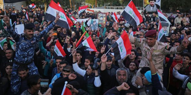Iraqis wave their national flag in Baghdad's Tahrir Square on December 10, 2017, during a gathering celebrating the end of the three-year war against the Islamic State (IS) group.Baghdad declared victory in its war to expel the jihadists, three years after the group proclaimed a cross-border 'caliphate' stretching into Syria, endangering Iraq's very existence. / AFP PHOTO / AHMAD AL-RUBAYE (Photo credit should read AHMAD AL-RUBAYE/AFP/Getty Images)