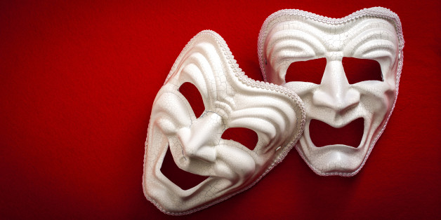 Comedy and Tragedy theatrical mask isolated on a red background and copy space