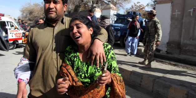 A man and a woman react as they run out after gunmen attacked the Bethel Memorial Methodist Church in Quetta, Pakistan December 17, 2017. REUTERS/Naseer Ahmed