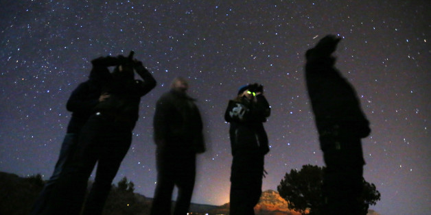 People use night vision goggles to look at the night sky during an Unidentified Flying Object (UFO) tour in the desert outside Sedona, Arizona February 14, 2013. Picture taken February 14, 2013. REUTERS/Mike Blake (UNITED STATES - Tags: SOCIETY SCIENCE TECHNOLOGY TPX IMAGES OF THE DAY)