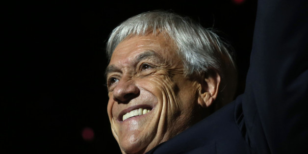 Chilean presidential candidate Sebastian Pinera celebrates his victory with his family and supporters outside a hotel in Santiago after the runoff election on December 17, 2017.Conservative billionaire Sebastian Pinera will return as Chile's president, the election results show. His rival, leftist challenger Alejandro Guillier, a TV presenter turned senator who ran as an independent but was backed by outgoing center-left President Michelle Bachelet, recognized his defeat. / AFP PHOTO / CLAUDIO