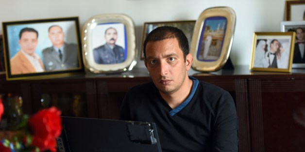 Tunisian blogger Yassine Ayari works on his laptop at home on April 17, 2015 in Tunis. Tunisian authorities have released a blogger handed six months in prison for defaming the army, after he served more than half his sentence, his brother said. AFP PHOTO / FETHI BELAID (Photo credit should read FETHI BELAID/AFP/Getty Images)