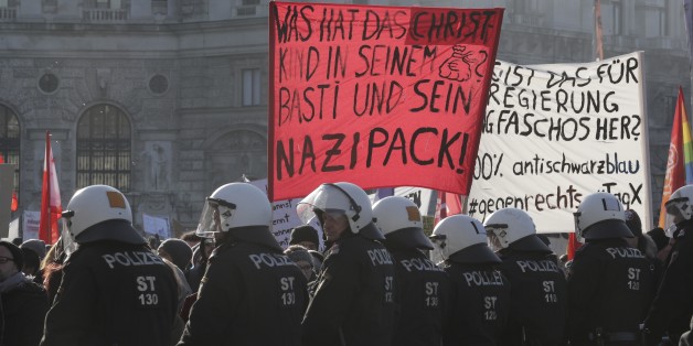 Austrian riot police guard protesters in front of the parliament during the swearing-in ceremony of the new government in Vienna, December 18, 2017 REUTERS/Heinz-Peter Bader