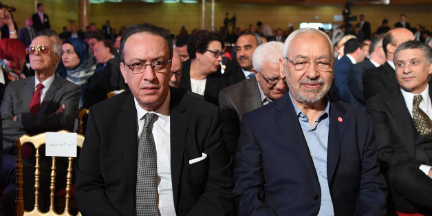 Hafedh Caid Essebsi (L), leader of Nidaa Tounes party, and Tunisian Islamist Ennahdha party leader Rached Ghannouchi, look on as they attend an official speech delivered by the Tunisian President Beji Caid Essebsi (unseen) on May 10, 2017 in Tunis.Essebsi said that the army will protect the output of Tunisia's main resources from being disrupted by protests over social and labour issues. / AFP PHOTO / FETHI BELAID (Photo credit should read FETHI BELAID/AFP/Getty Images)