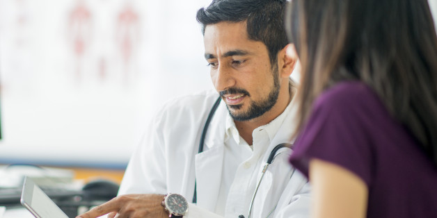 A doctor is talking to a patient about her condition at her appointment.