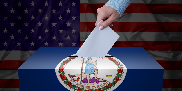 A hand casting a vote in a ballot box for an election in the Virginia, USA