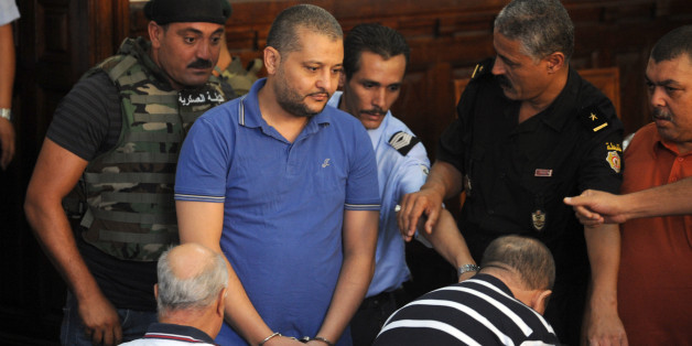 The nephew of the deposed President of Tunisia Zine El Abidine Ben Ali, Imed Trabelsi (C), arrives for a thrid trial hearing, at a court in Tunis, on August 10, 2011. The trial resumed of 23 relatives and allies of Tunisia's ousted president on charges of trying to illegally flee the country loaded with jewels and cash at the climax of January's revolt. AFP PHOTO / FETHI BELAID (Photo credit should read FETHI BELAID/AFP/Getty Images)