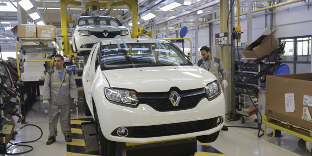 Employees work in the new Renault factory in Oran, west of Algiers November 10, 2014. French carmaker Renault said on Monday it was targeting annual production capacity of 25,000 vehicles at a new plant in Oran, Algeria, and that it was considering increasing this to 75,000 vehicles. Renault, which said it was Algeria's biggest carmaker with a market share of more than 25 percent, owns 49 percent of the plant and has made an initial investment of 50 million euros ($62 million), it said in a stat
