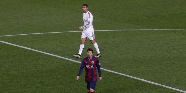 Barcelona's Argentinian forward Lionel Messi (DOWN) and Real Madrid's Portuguese forward Cristiano Ronaldo walk on the field during the 'clasico' Spanish league football match FC Barcelona vs Real Madrid CF at the Camp Nou stadium in Barcelona on March 22, 2015. AFP PHOTO / QUIQUE GARCIA (Photo credit should read QUIQUE GARCIA/AFP/Getty Images)