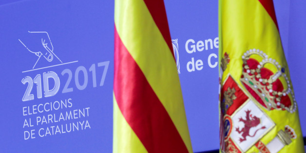 Spanish and Catalan flags are displayed in the main press center for tomorrow's regional elections in Barcelona, Spain December 20, 2017. REUTERS/Eric Gaillard