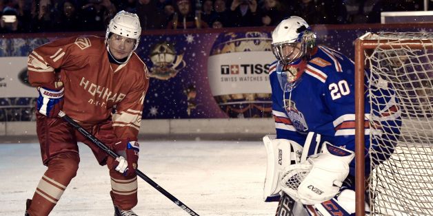 Russian President Vladimir Putin (L) takes part in the Night Hockey League match on the GUM department store skating rink at Red Square in Moscow on December 22, 2017. / AFP PHOTO / Sputnik / Alexey NIKOLSKY (Photo credit should read ALEXEY NIKOLSKY/AFP/Getty Images)