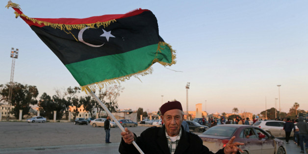 A man holds a Libyan flag as he celebrates the sixth anniversary of the Libyan revolution, in Benghazi, Libya February 17, 2017. REUTERS/Esam Omran Al-Fetori