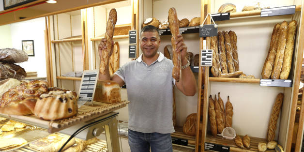 Parisian baker Ridha Khadher, winner of the Best Baguette of Paris 2013 award, holds his baguettes, French bread, as he poses in his bakery after the verdict in Paris April 25, 2013. The baguette is a French cultural symbol par excellence and the competition saw 203 Parisian bakers who compete for recognition as finest purveyor of one of France's most iconic staples. The baguettes are registered, given anonymous white wrappings and an identification number. They are then carefully weighed and me