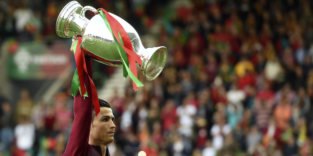 Portugal's forward Cristiano Ronaldo raises the EURO 2016 trophy prior tog the friendly football match Portugal vs Sweden at the Estadio dos Barreiros in Funchal on March 28, 2017. / AFP PHOTO / FRANCISCO LEONG (Photo credit should read FRANCISCO LEONG/AFP/Getty Images)