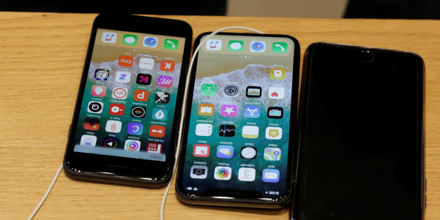 An Apple iPhone X model (C) is seen next to older models of iPhone on a table at an Apple store in New York, U.S., November 3, 2017. REUTERS/Lucas Jackson