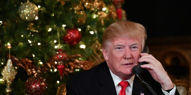 US President Donald J. Trump participates in NORAD Santa Tracker phone calls at the Mar-a-Lago resort in Palm Beach, Florida on December 24, 2017. 'NORAD Tracks Santa' is an annual Christmas-themed entertainment program, which has existed since 1955, produced under the auspices of the North American Aerospace Defense Command. / AFP PHOTO / Nicholas Kamm (Photo credit should read NICHOLAS KAMM/AFP/Getty Images)