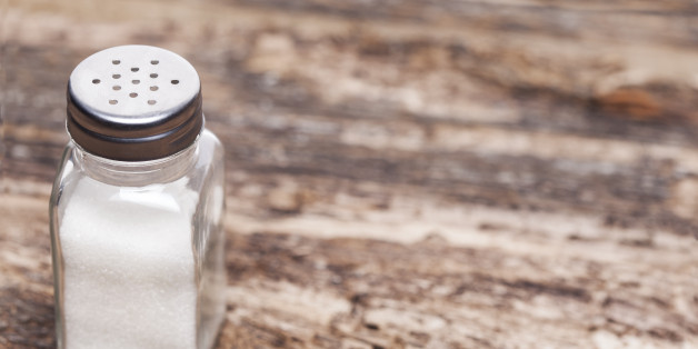 Salt shaker on wooden table
