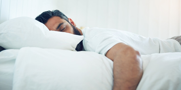 Shot of a mature man lying on his bed and sleeping