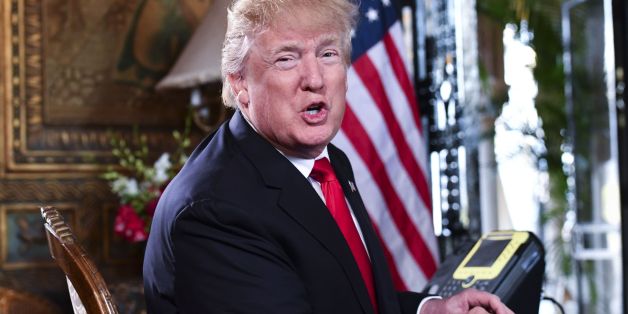 US President Donald J. Trump speaks to the media before participating in a video teleconference calls with military members on Christmas Eve in Palm Beach, Florida on December 24, 2017. / AFP PHOTO / Nicholas Kamm (Photo credit should read NICHOLAS KAMM/AFP/Getty Images)