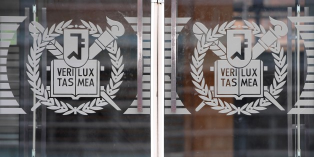 This picture taken on December 14, 2017 shows the logo of Seoul National University on a glass door at the university in southern Seoul. / AFP PHOTO / JUNG Yeon-Je (Photo credit should read JUNG YEON-JE/AFP/Getty Images)