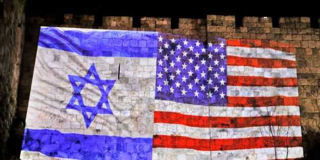 A picture taken on December 6, 2017 shows a giant US flag screened alongside Israel's national flag by the Jerusalem municipality on the walls of the old city.US President Donald Trump recognized the disputed city of Jerusalem as Israel's capital on December 6, 2017, and kicked off the process of relocating the US embassy there from Tel Aviv.The old city lies in the eastern part of Jerusalem which was under Jordanian control from Israel's creation in 1948 until Israeli forces captured it during