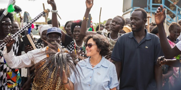 Special Representative of the United Nations Secretary-General for Children and Armed Conflict Leila Zerrougui (C) is welcomed by the Nuer community in a South Sudanese internally displaced people (IDP) camp at UN House, the UNMISS (United Nations Mission in the Republic of South Sudan) compound on the southwestern outskirts of Juba, on June 23, 2014, during a joint visit by a UNESCO high delegation and the Special Representative of the United Nations' Secretary-General for Children and Armed Co