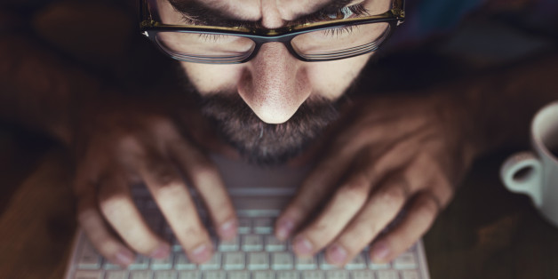 Computer hacker stealing information with laptop