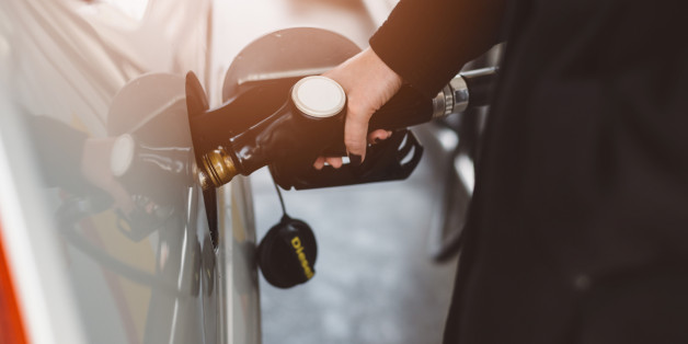 Woman refueling car with diesel at the gas station