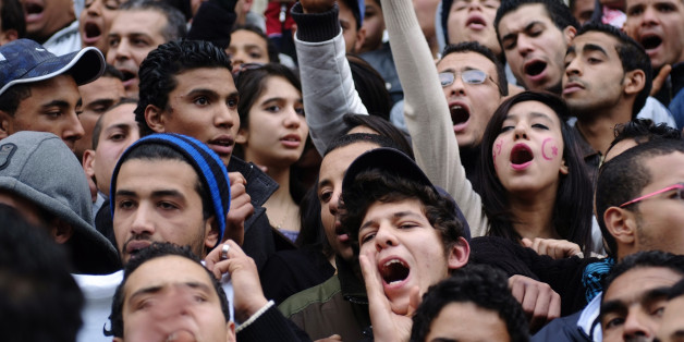 Tunisians celebrate the first year anniversary of the revolution in Tunis January 14, 2012. Tunisians on Saturday marked the first anniversary of the revolution that started the "Arab Spring" with celebrations that were true to the spirit of the revolt: raucous, unscripted, and driven by the energy of ordinary people. Thousands of people flooded into Bourguiba Avenue in the centre of the capital, the same spot where demonstrators massed exactly one year ago, forcing autocratic leader Zine al-Abidine Ben Ali to accept his rule was over and flee the country. REUTERS/Anis Mili (TUNISIA - Tags: POLITICS CIVIL UNREST)