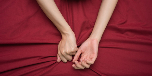 hand grasping on bed sheet