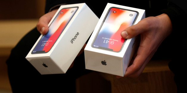 A man holds two boxes for the Appleâs new iPhone X which went on sale today, at the Apple Store in Regents Street in London, Britain, November 3, 2017. REUTERS/Peter Nicholls
