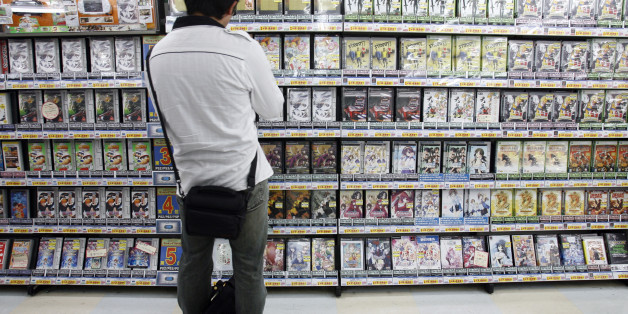 A man looks at video games at a shop in Tokyo's Akihabara district June 9, 2008. REUTERS/Yuriko Nakao (JAPAN)