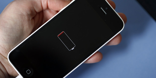 PARIS, FRANCE - DECEMBER 23: In this photo illustration a woman holds an Apple mobile phone iPhone 5 on the screen of which we can see the battery charge indicator on December 23, 2017 in Paris, France. Apple has admitted that it was clamping the processors of old iPhone at certain stages of their life cycles, to deliberately slow down the performance of batteries of older models of iPhone. (Photo by Chesnot/Getty Images)