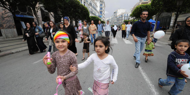 Algerian children with their families walk in Algiers' main street of Didouch Mourad on May 16, 2008 as the local municipality authorities called for a 'day without vehicles' in the capital's center. The municipality asked residents to walk, bike and ride on public transport instead of driving cars for reducing pollution. AFP PHOTO/FAYEZ NURELDINE (Photo credit should read FAYEZ NURELDINE/AFP/Getty Images)