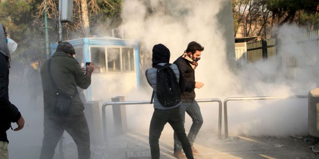 Iranian students run for cover from tear gas at the University of Tehran during a demonstration driven by anger over economic problems, in the capital Tehran on December 30, 2017.
Students protested in a third day of demonstrations, videos on social media showed, but were outnumbered by counter-demonstrators. / AFP PHOTO / STR (Photo credit should read STR/AFP/Getty Images)