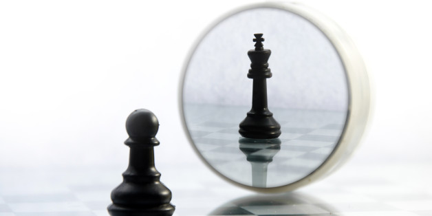 pawn pieces on the chessboard, the reflection in the mirror king, often in life things and people are not what they seem