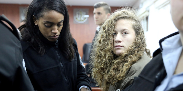 Palestinian teen Ahed Tamimi (R) enters a military courtroom escorted by Israeli Prison Service personnel at Ofer Prison, near the West Bank city of Ramallah, January 1, 2018. REUTERS/Ammar Awad TPX IMAGES OF THE DAY