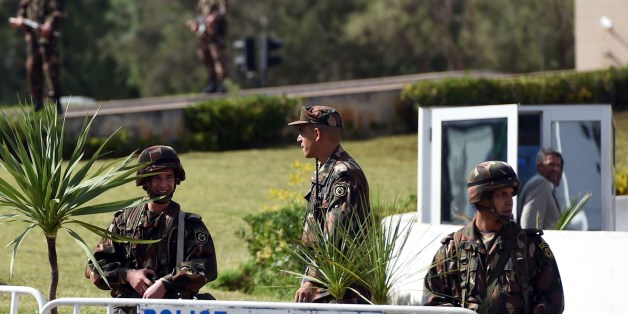 Members of the Algerian Republican Guard stand guard outside the presidential palace on October 16, 2014 in the capital Algiers, as police forces demonstrate over working conditions next to the building. AFP PHOTO/FAROUK BATICHE (Photo credit should read FAROUK BATICHE/AFP/Getty Images)