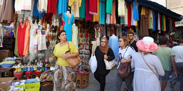 People walk past a clothes shop in Tunis, Tunisia, September 21, 2017 REUTERS/Zoubeir Souissi
