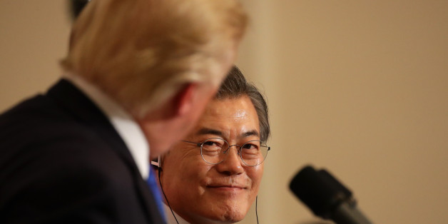 U.S. President Donald Trump, left, looks at Moon Jae-in, South Korea's president, during a news conference at the presidential Blue House in Seoul, South Korea, on Tuesday, Nov. 7, 2017. Trump said that North Korea should come to the table and make a deal on its missile and nuclear programs. Photographer: SeongJoon Cho/Bloomberg via Getty Images