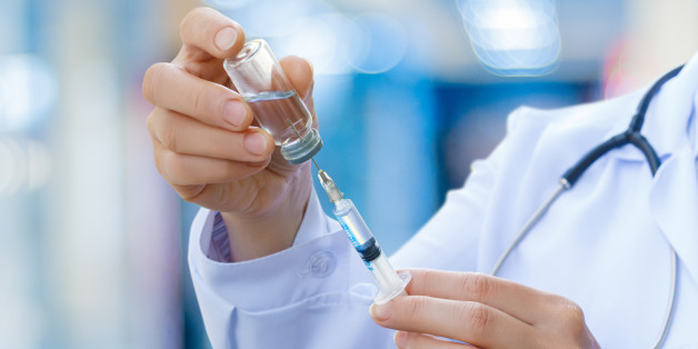 The doctor prepares the syringe with the cure for vaccination.