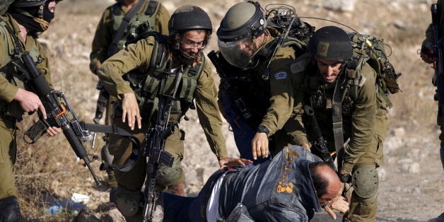 Israeli soldiers detain a Palestinian protester during clashes following a protest against Jewish settlements, in Jalazoun refugee camp, near the West Bank city of Ramallah June 12, 2015. REUTERS/Mohamad Torokman TPX IMAGES OF THE DAY TPX IMAGES OF THE DAY