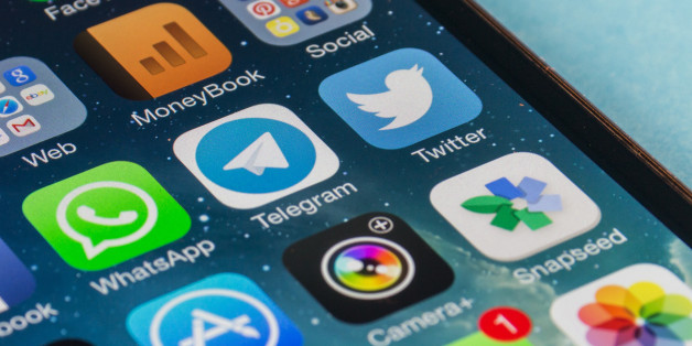 Florence, Italy - March 01, 2014: Apple iPhone 5s screen with instant messaging applications of WhatsApp, Facebook, Telegram, Twitter