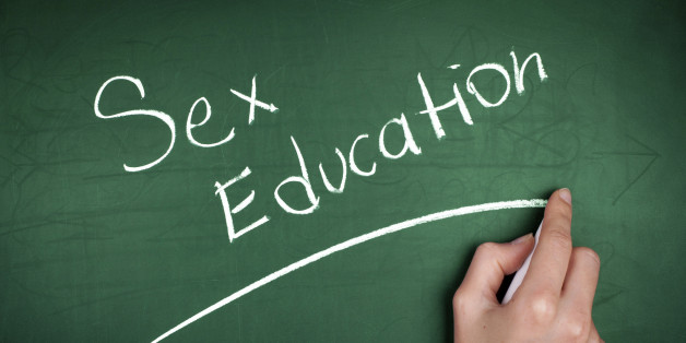 Woman hand writing 'Sex Education' on green blackboard